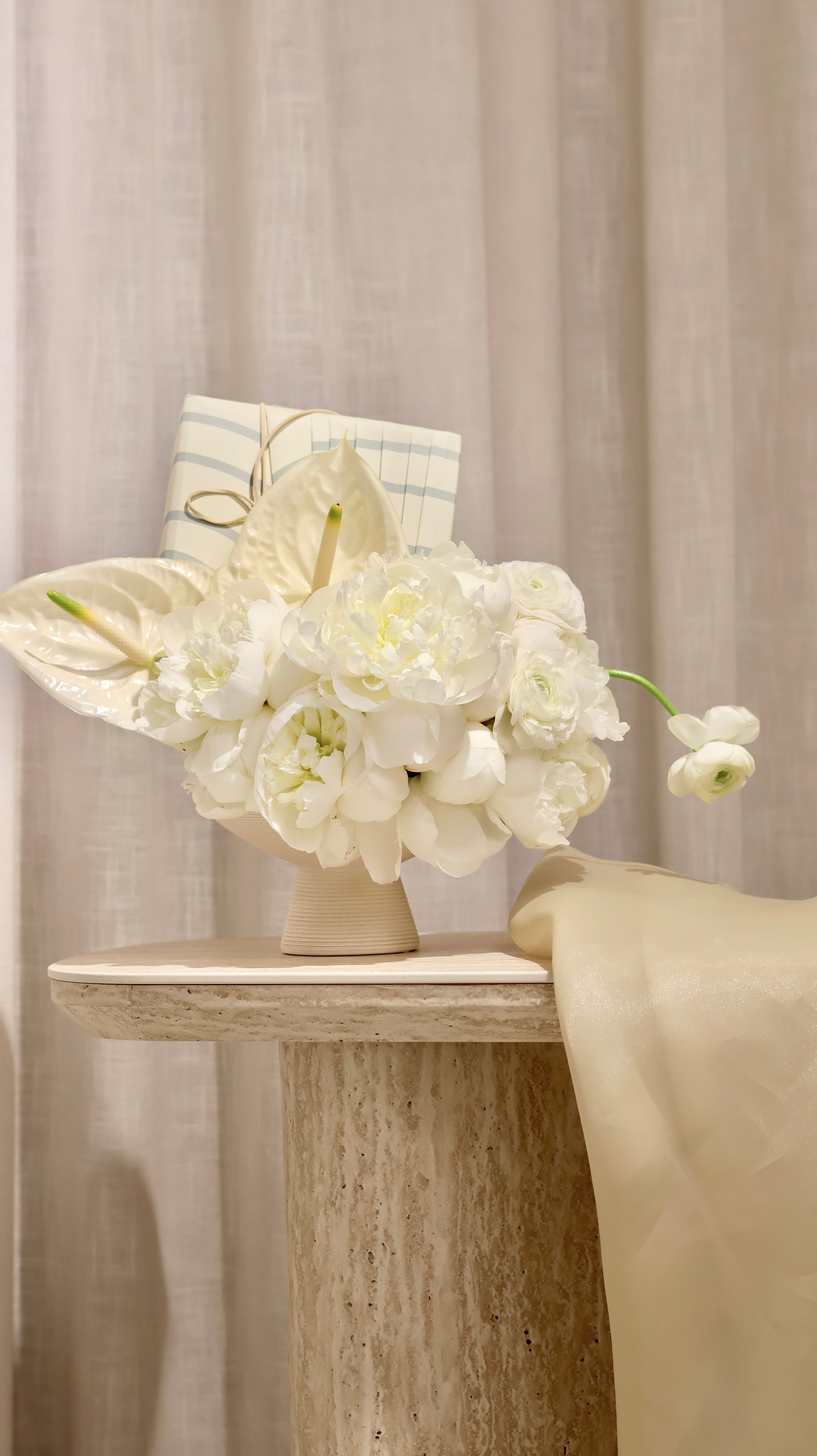 Gifting with a White Floral Arrangement in a Vase