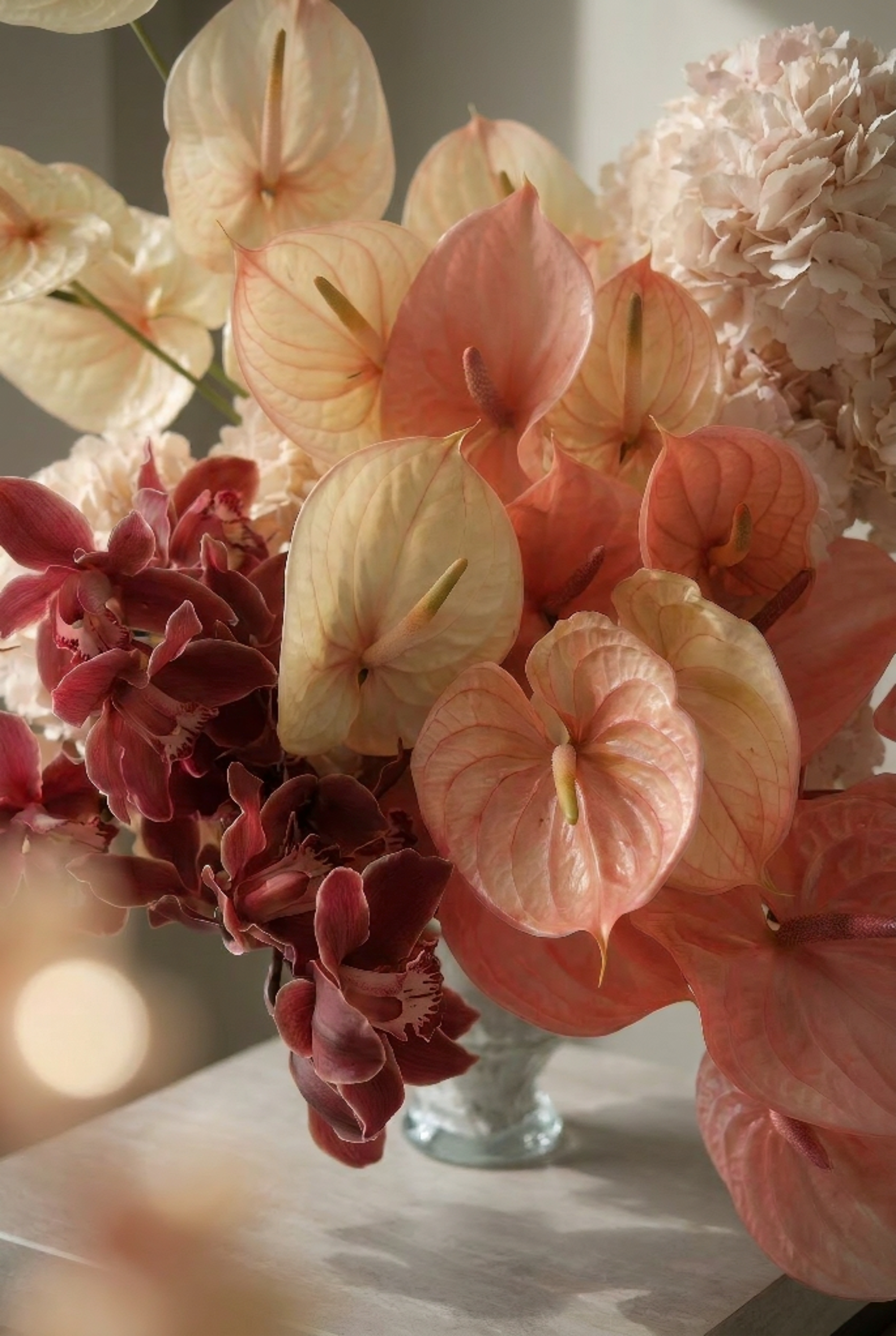 Red and Peach Floral Arrangement in a Crystal Vase