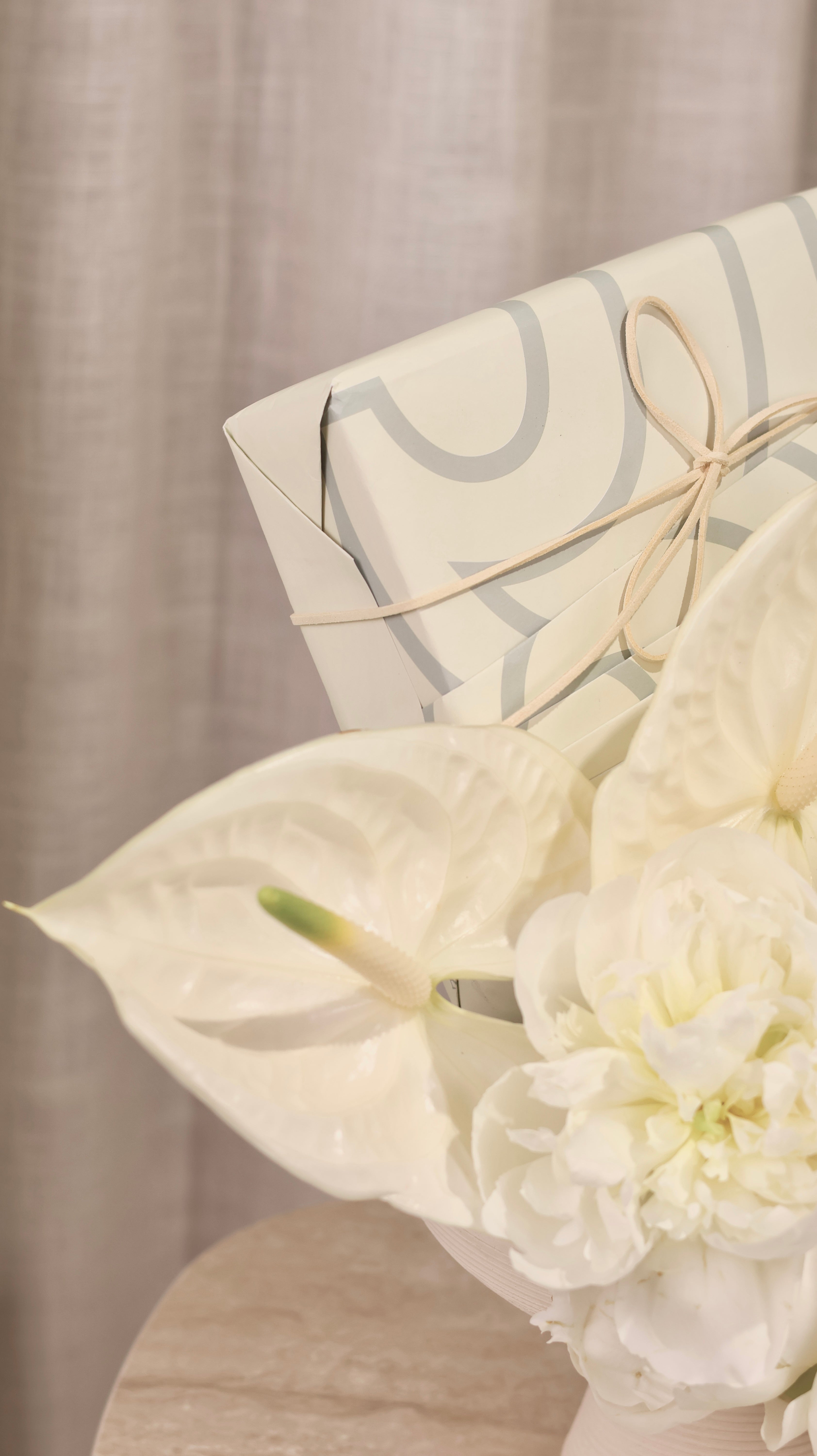 Gifting with a White Floral Arrangement in a Vase