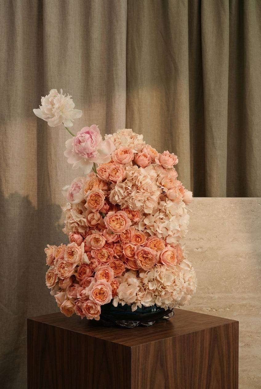 Peach and Blush Floral Arrangement in a Black Glass Vase