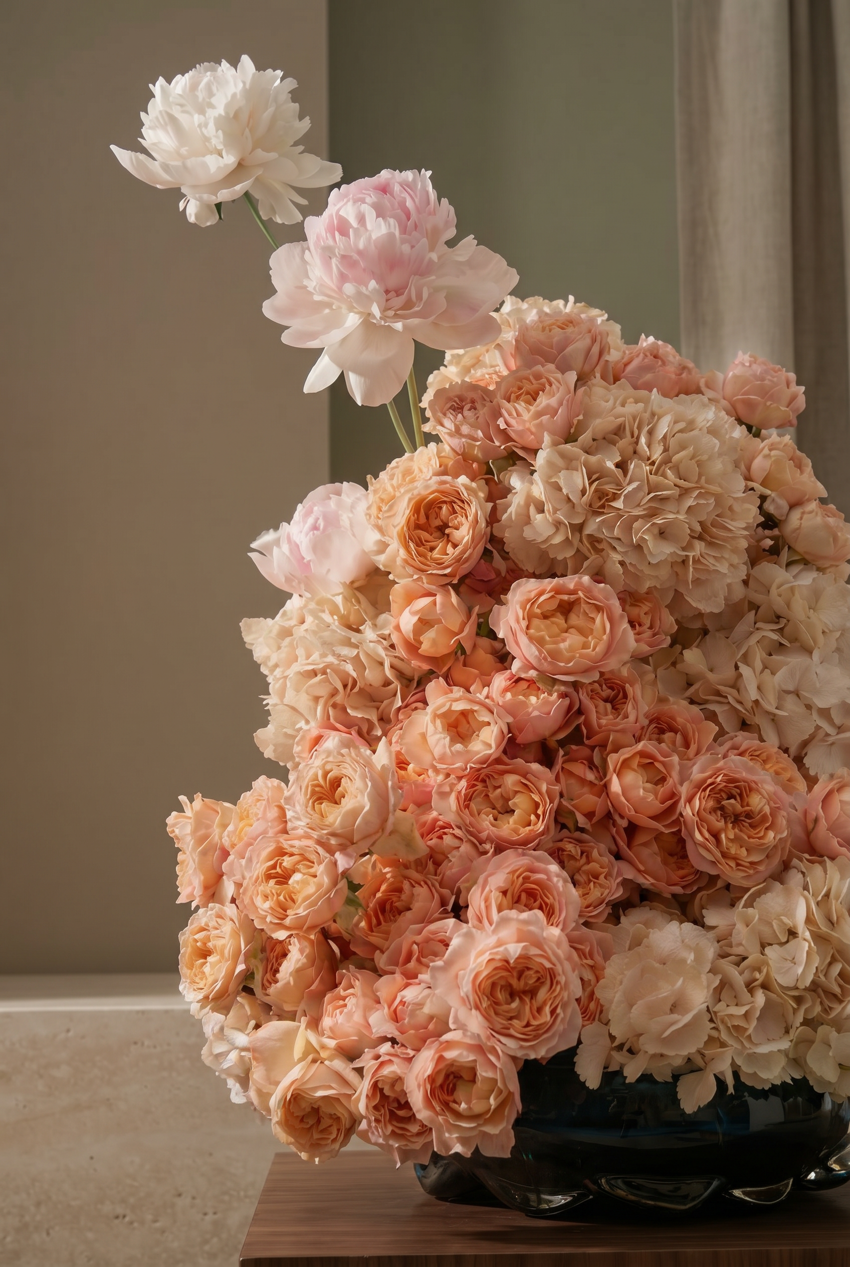 Peach and Blush Floral Arrangement in a Black Glass Vase